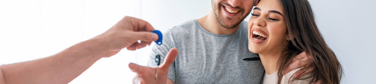 A young couple accepting new house keys