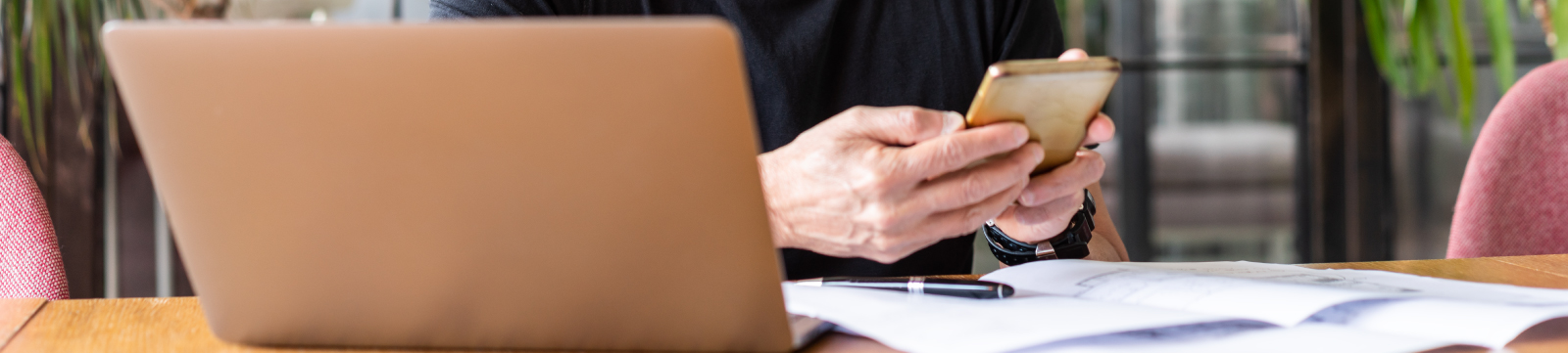 A man using his laptop and mobile phone